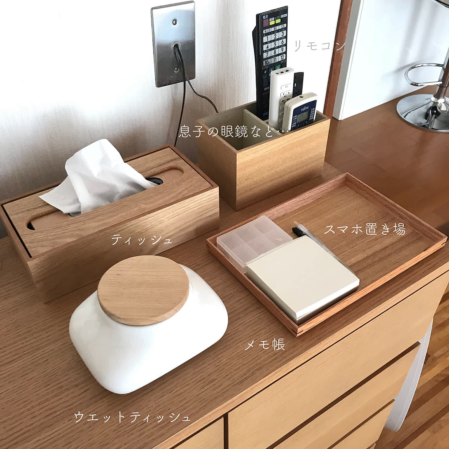 A well-organized dresser top with wooden organizers and containers
